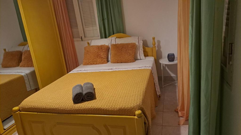 a bedroom with two beds with slippers on them at Casa Mendes in Tarrafal