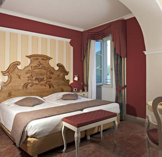 Vuode tai vuoteita majoituspaikassa Hotel Cannobio