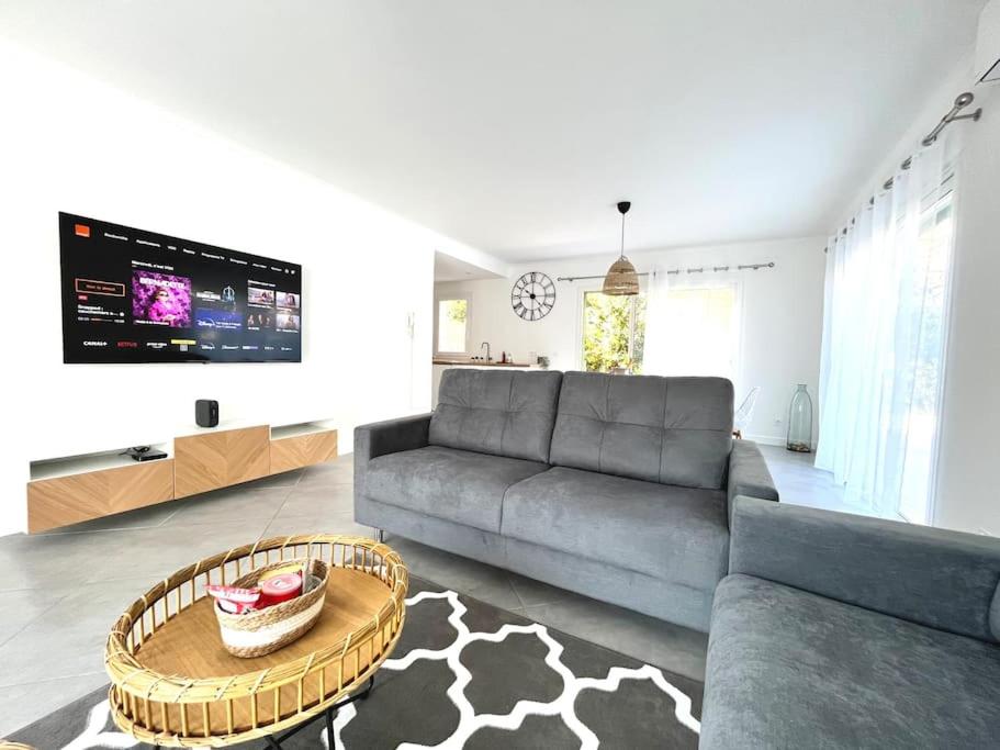 a living room with a couch and a table at Villa Victoria #8 persons #3 Bedrooms #Terrace # garage Beach - Calm and Clim in Roquebrune-Cap-Martin