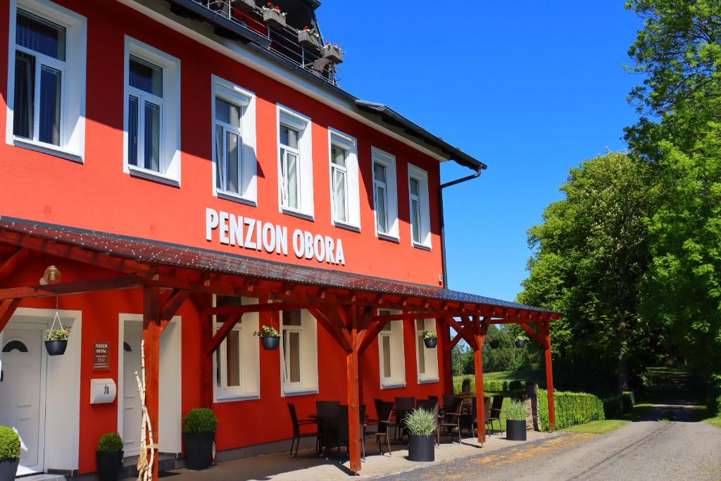 a red building with a sign that reads pension covenant at Penzion Obora in Tachov