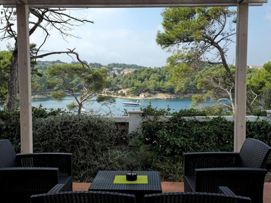 a porch with a view of a river and a boat at Studio Dubravka in Mali Lošinj