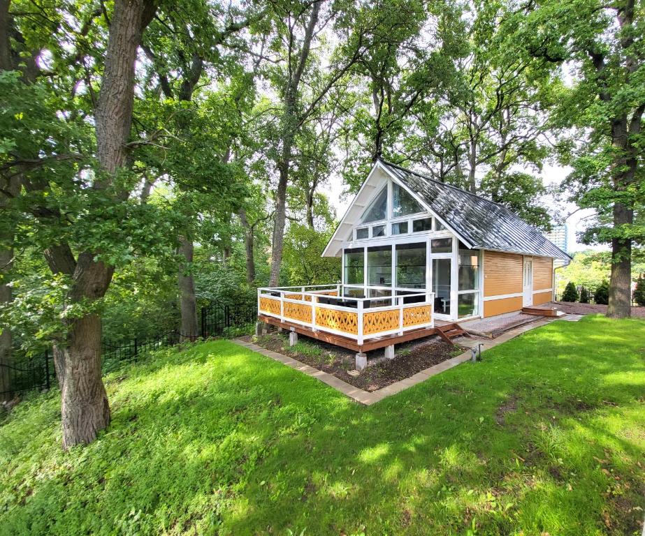 a small house in the middle of a yard at Beautiful lakefront house in Västerås