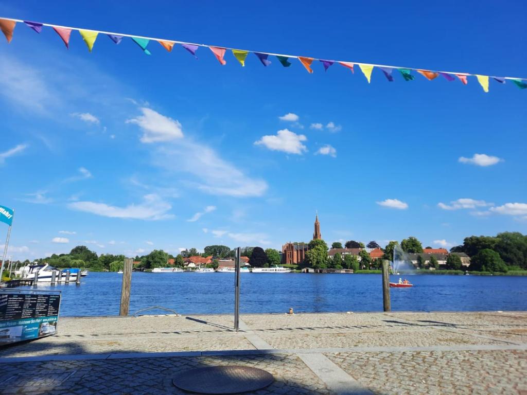 a string of flags hanging over a body of water at Wald und Wasser in Malchow