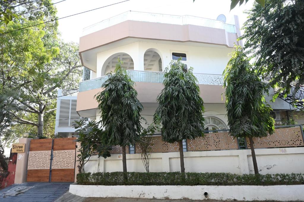 a white building with trees in front of it at SHREE VILLA in Jaipur