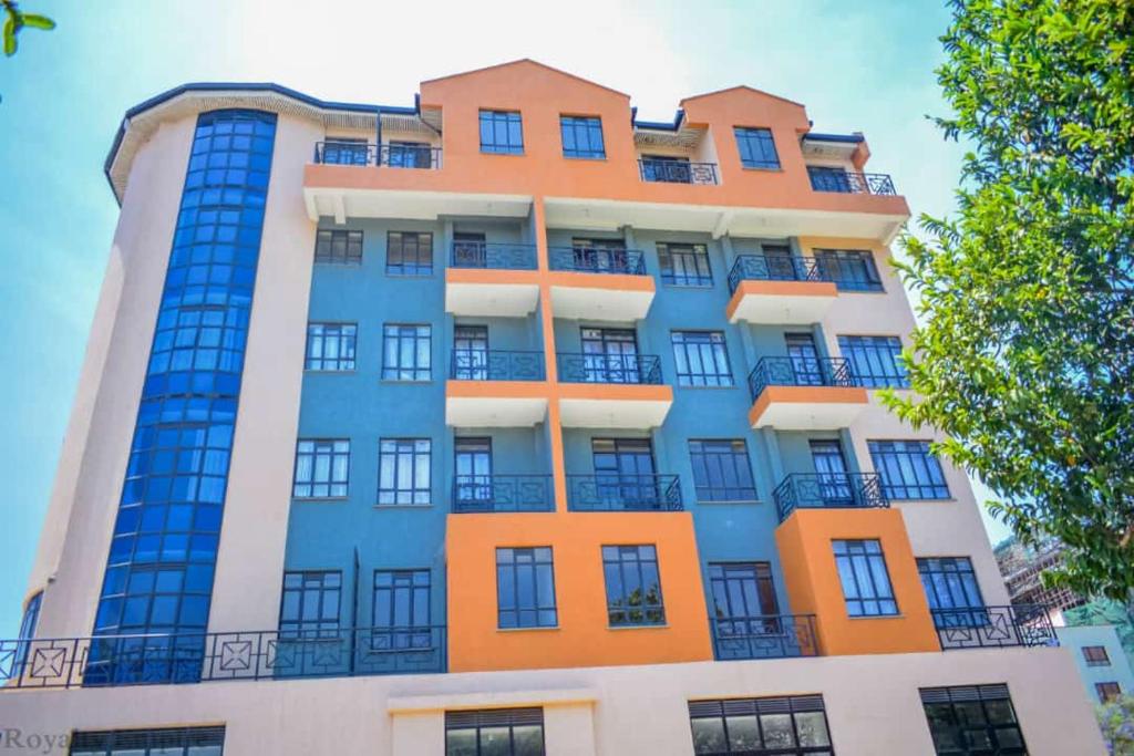 a tall building with orange and blue at Cosy Studio Apartment in Nakuru.Lift.Wifi.Ample Parking in Nakuru