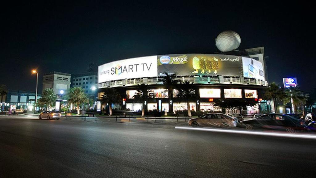 a large building on a city street at night at Premium apartment in new cairo in Cairo