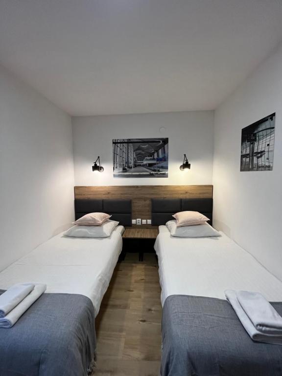 two twin beds in a room with at Terminal in Poznań