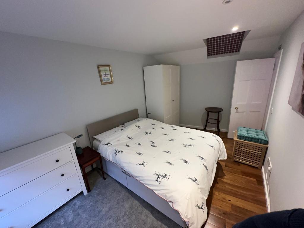 a small bedroom with a bed and a dresser at One Bee in Edinburgh