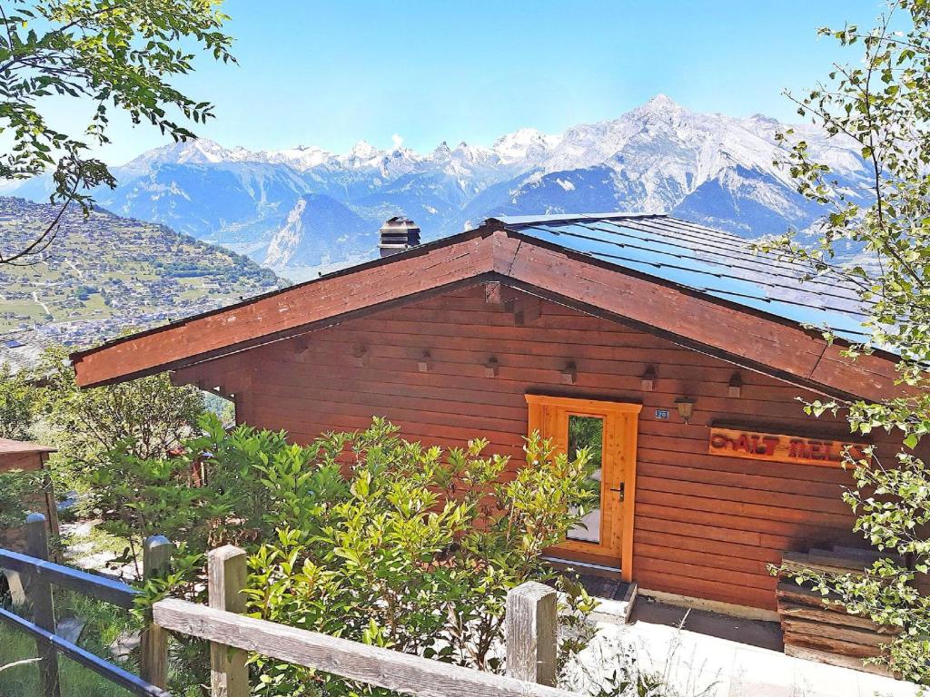 a small wooden cabin with mountains in the background at chalet for 6 people with views of Veysonnaz in Veysonnaz