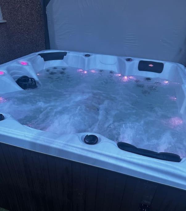a jacuzzi tub filled with lots of steam at The Porty Beach House in Edinburgh