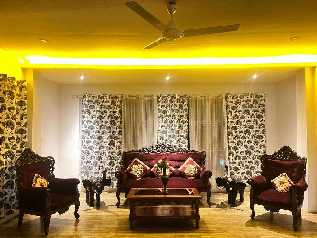 a living room with a couch and two chairs at Move Inn- The suite in Dibrugarh