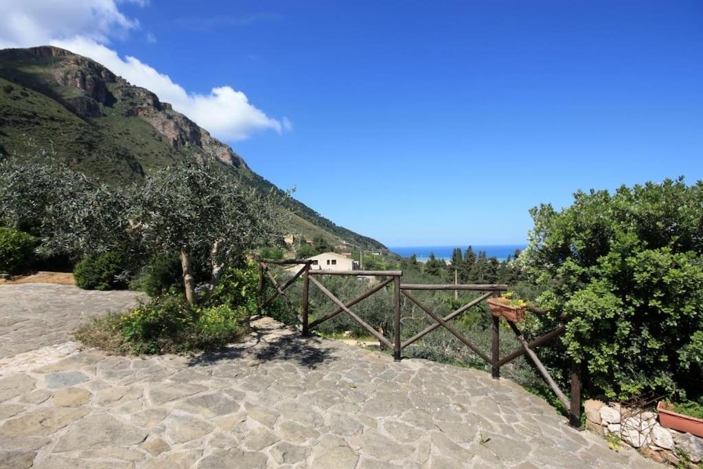 a house on a hill next to a mountain at Dolce Dormire Home Holiday in Castellammare del Golfo