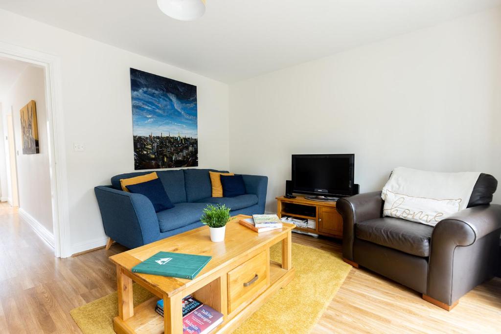 a living room with a couch and a chair at BRIARS CLOSE - Four Bed Property on the Edge of the Peak District National Park in Buxton