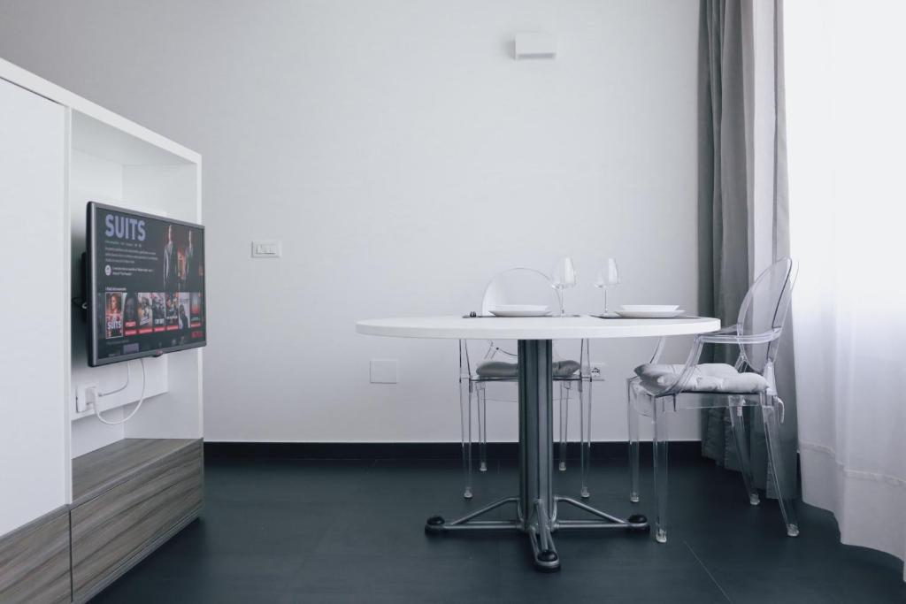 uma mesa branca e cadeiras num quarto em Ugo's Urban Home: Porta Nuova District em Milão