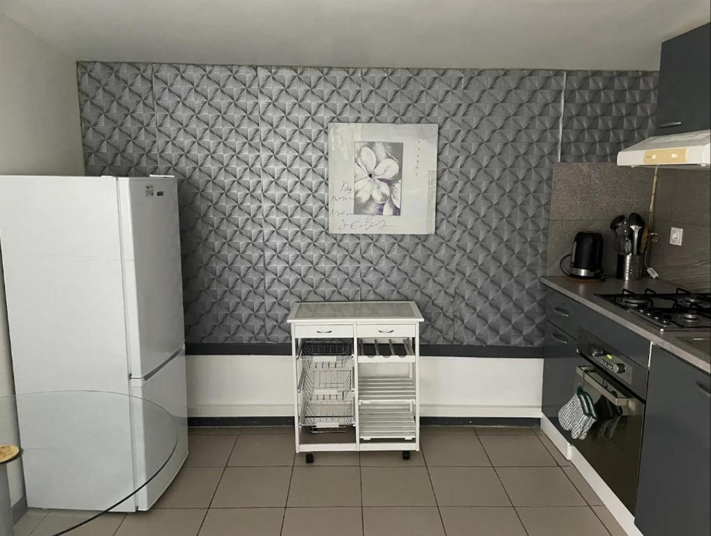 a kitchen with a refrigerator and a counter in it at Maisonnette les fabrettes in Marseille