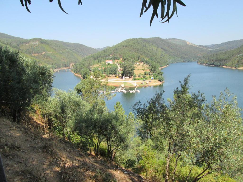 an island in the middle of a lake at Casa do Rio in Figueiró dos Vinhos