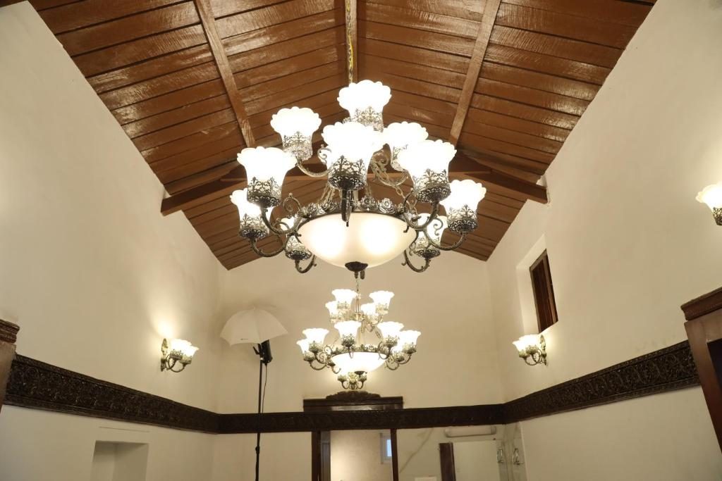 a ceiling with a chandelier in a room at Pear Tree Luxe Entire 3BHK Mansion in Kotagiri