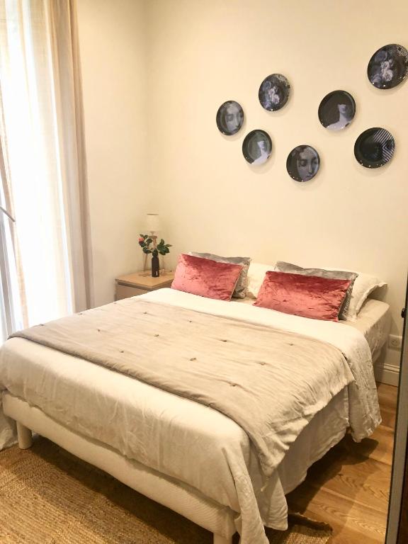 a bedroom with a bed with plates on the wall at Riviera Donia House in Nice