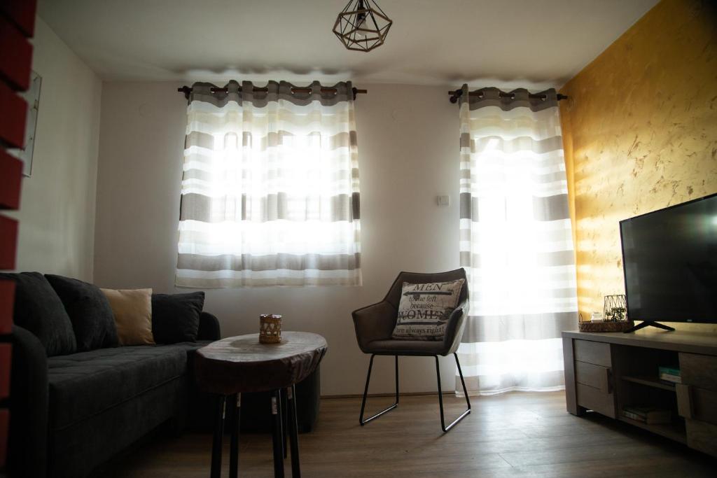 a living room with a couch and a chair at Holiday home Sunce i Zora in Jalžabet