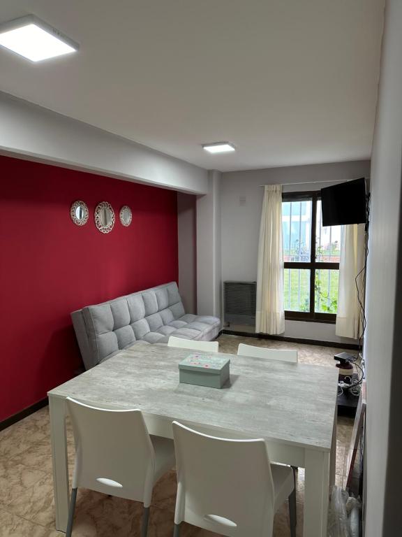 a living room with a table and a couch at Paseo Costero Apart in Comodoro Rivadavia
