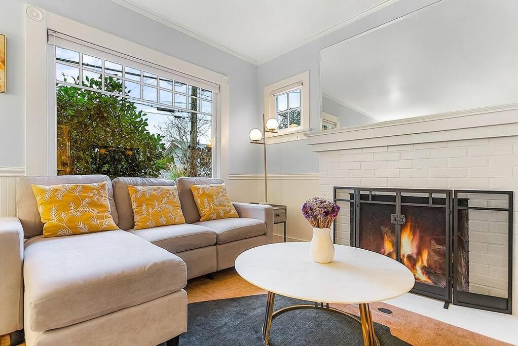 a living room with a couch and a fireplace at Skyline Blue House in Greenwood in Seattle