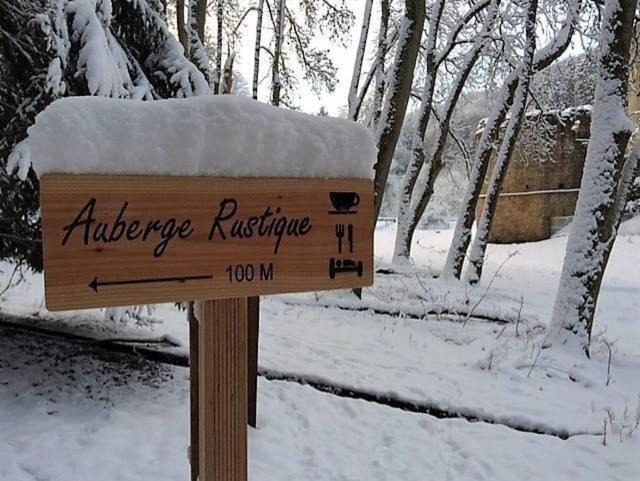 a sign for an entrance to an airplane refuge in the snow at Hotel Auberge Rustique in Beaufort