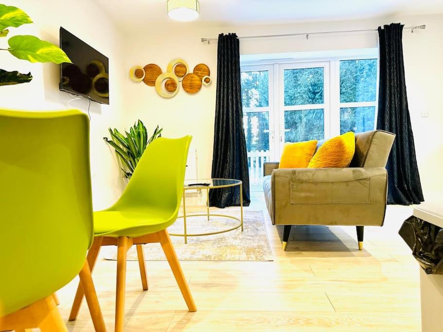 a living room with a yellow chair and a couch at Stylish Dover Apt With Castle View in Kent