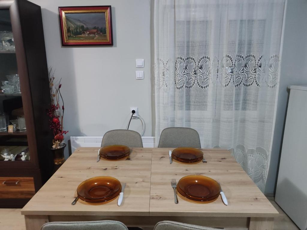 a wooden table with plates on top of it at Apartman - GOLEMI MOST in Pirot
