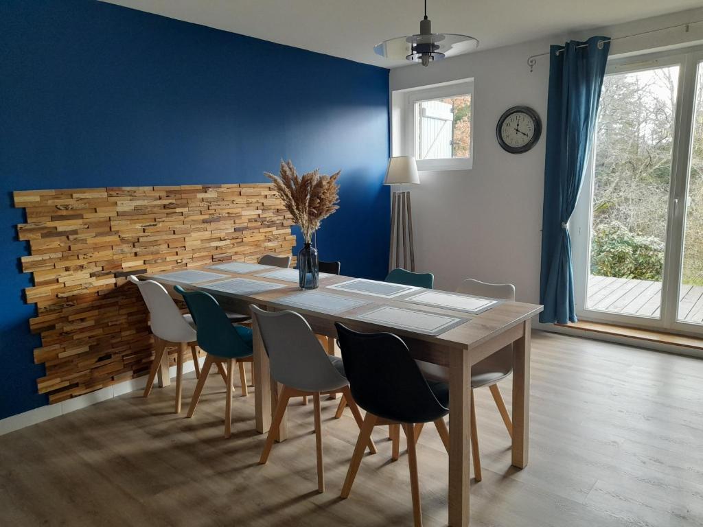 a dining room with a wooden table and chairs at L'AMANDAURE in Saulcy-sur-Meurthe