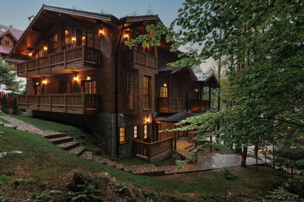 a large wooden house with lights on it at Chalet Royal in Sinaia