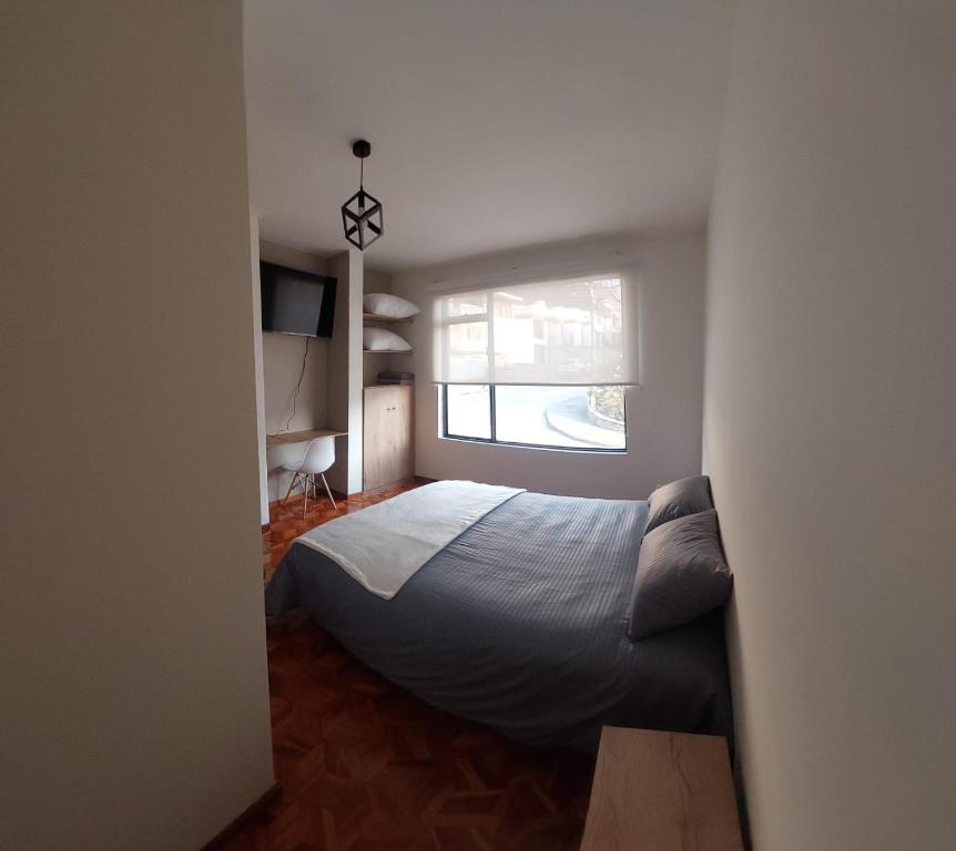 a bedroom with a bed and a window at Casa Palermo Manizales in Manizales