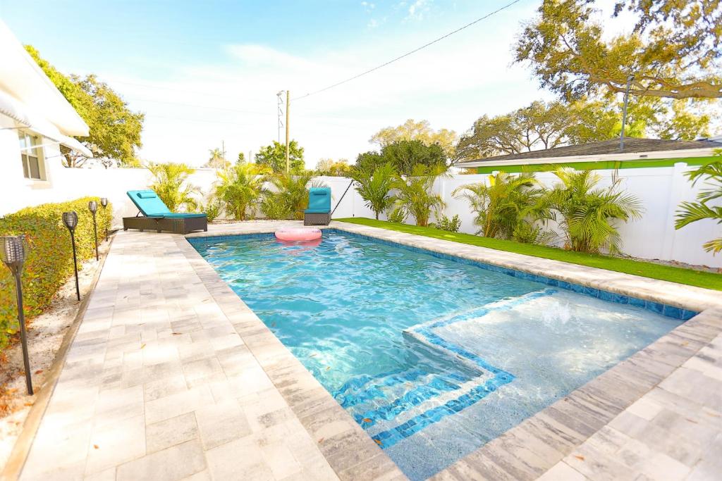 a swimming pool in the backyard of a house at Magnolia Home • Clearwater Beach • BBQ • Sunroom in Clearwater