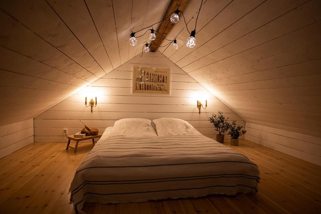 a bedroom with a large bed in a attic at Villa Lotta in Hanko