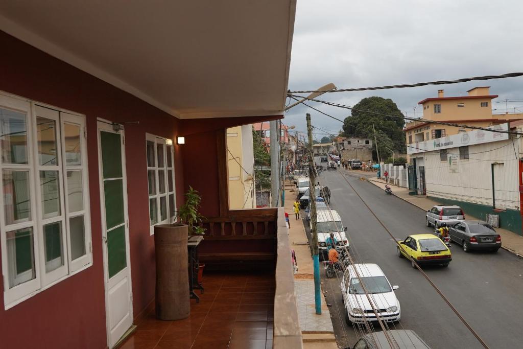 a view of a city street with cars parked on the street at Residencial Avenida Geovanni in São Tomé