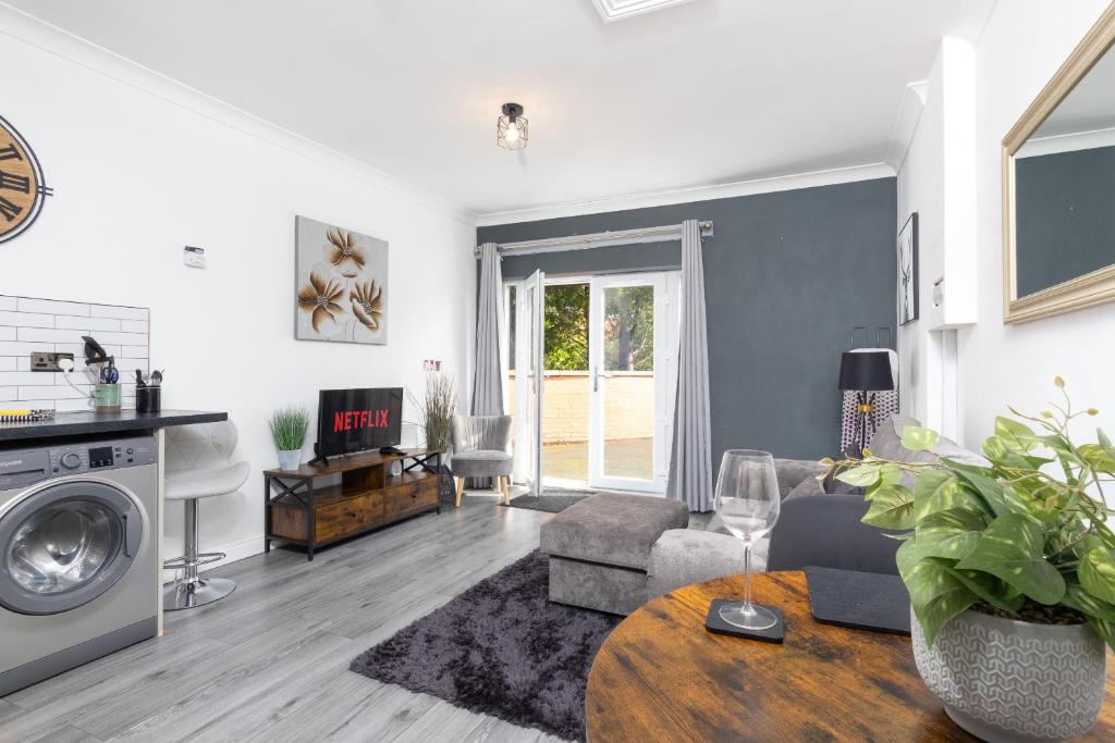 a living room with a couch and a table at 'The Lodge' Bedworth in Bedworth