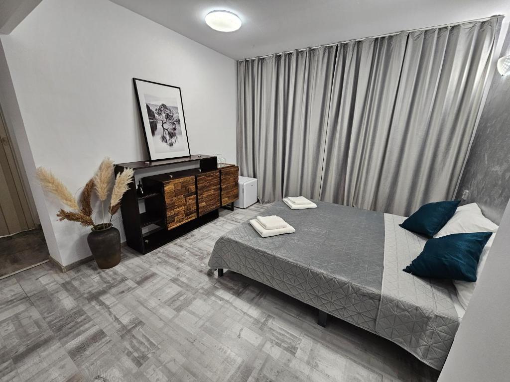 a bedroom with a large bed and a window at 24 Shades of Grey, apartament central, ceai, cafea, filtru apa rece-fierbinte, pat 160 cm cu saltea memory foam in Craiova