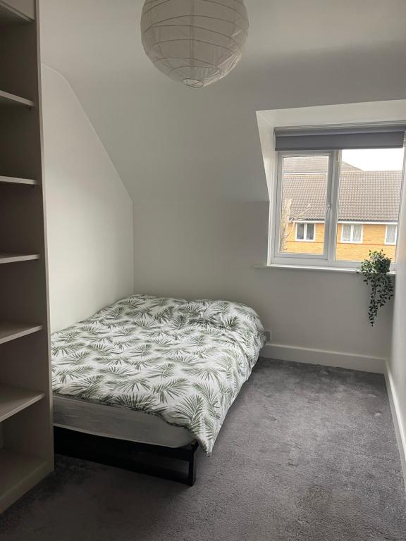 a bedroom with a bed and a window at Cityscape Executive House in Eltham