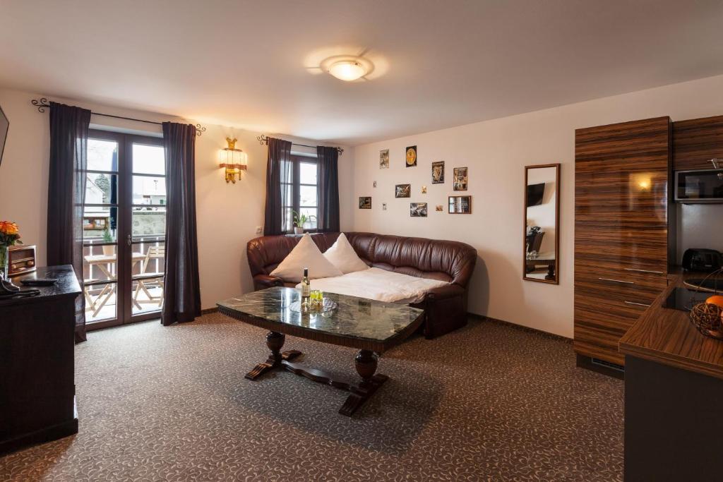 a living room with a couch and a coffee table at Vitusfort Appartement "Guinness Suite" in Füssen
