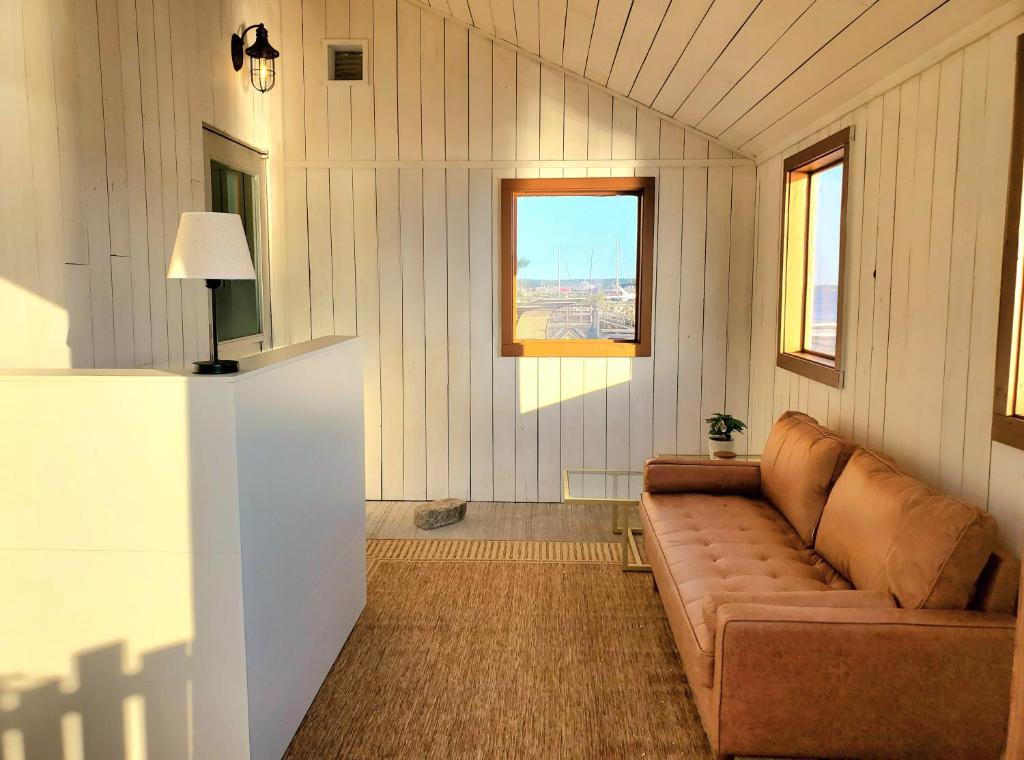 a living room with a couch and two windows at Albert's in Shelburne