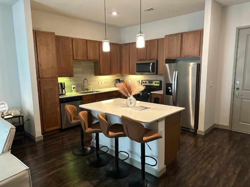 a kitchen with a table and chairs and a refrigerator at Downtown Houston Cozy Queen Suite in Houston