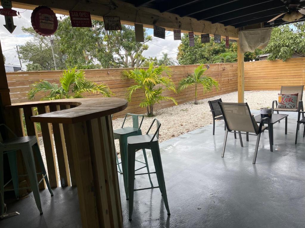 a patio with chairs and a table and a bar at “2-Bed- 1.5 Bath with outdoor bar in West Palm Beach