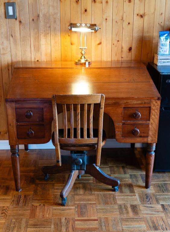 a desk with a chair and a lamp on top at Albert's in Shelburne