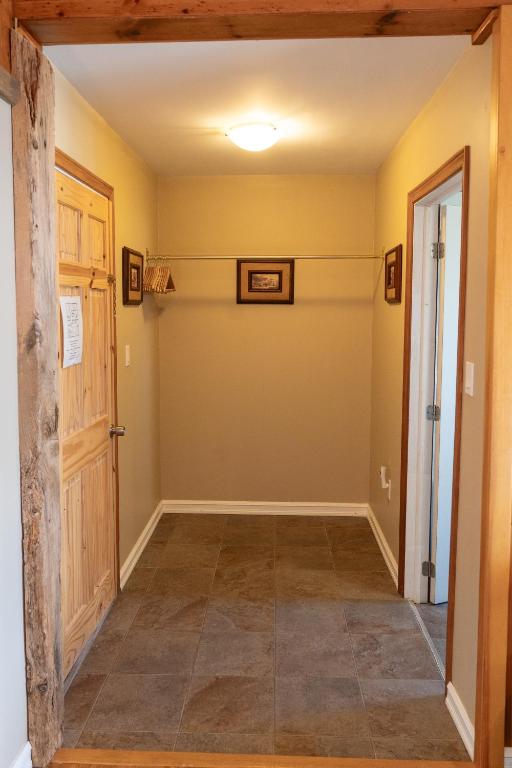 a hallway of a home with a door and tile floor at Albert's in Shelburne