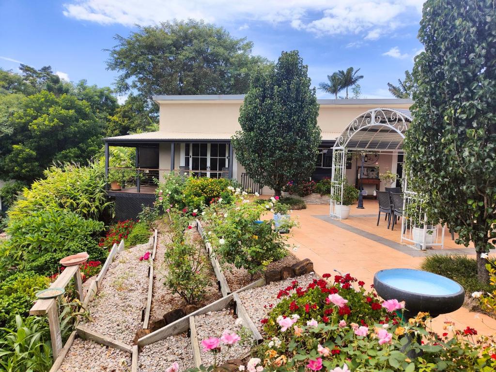 um jardim em frente a uma casa com flores em Hidden Valley Private Guest Suite with Views em South Grafton