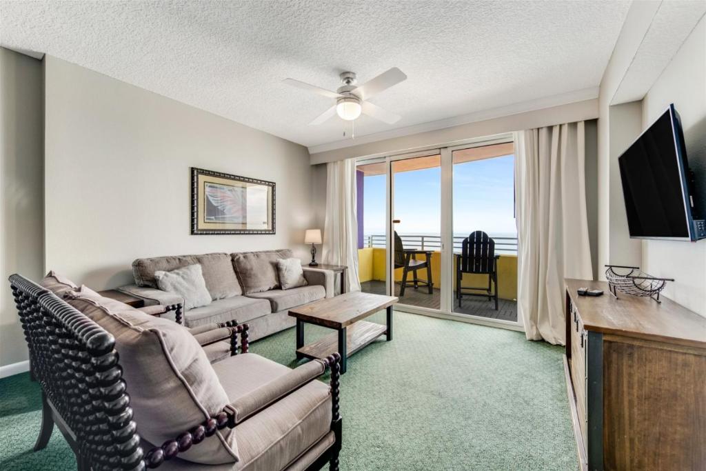 a living room with a couch and a tv at Unit 2224 Ocean Walk - 3 Bedroom Ocean Front in Daytona Beach