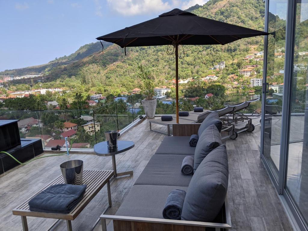 patio con divano e ombrellone di 360* Ultimate Penthouse Entire TOP FLOOR and RESORT with GREAT AMENITIES a Kamala Beach