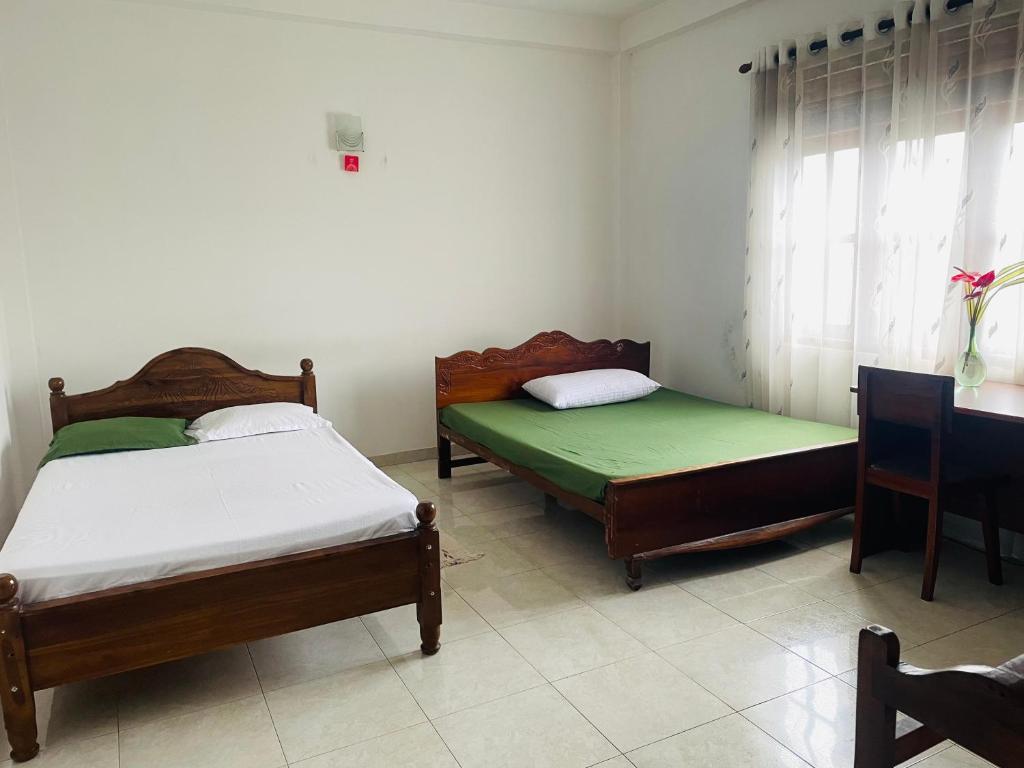 2 camas en una habitación con ventana en Thalalla resort, en Talalla South