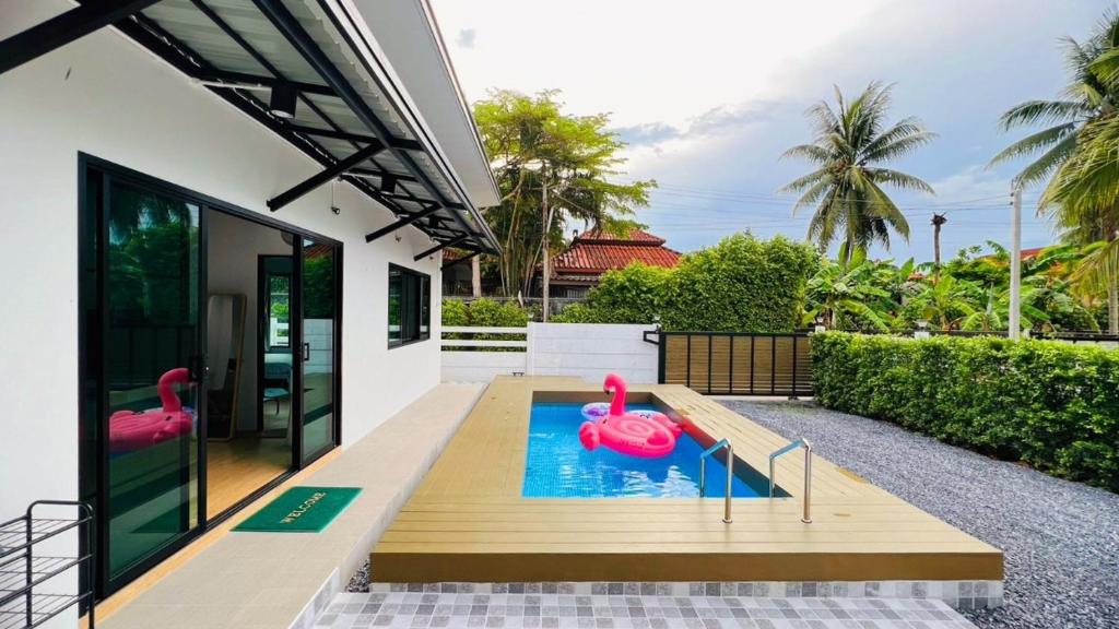 a swimming pool in the backyard of a house at Chalicha pool villa phatthalung in Khuan Khanun