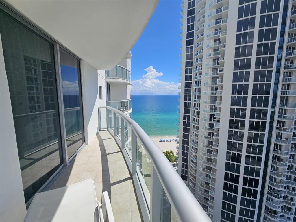 a balcony with a view of the beach and buildings at Mare-1708 A in Aventura