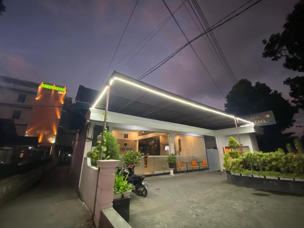 a house with a motorcycle parked in front of it at Green Hayaq Hotel in Selong